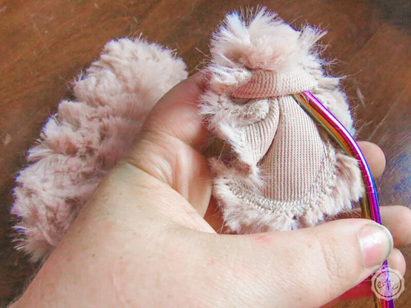 Using a metal straw to push the little bunny arms from inside out to the finished fuzzy side out.